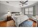 Relaxing main bedroom features a large window, neutral color palette, and a ceiling fan at 13209 Palmilla Cir, Dade City, FL 33525
