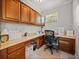 Functional office space with built-in desk, ample storage, and bright lighting at 13209 Palmilla Cir, Dade City, FL 33525