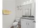 The half-bathroom features a toilet, granite countertop, vanity, mirror, light fixture, and decor at 13233 Canopy Creek Dr, Tampa, FL 33625