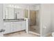 Bathroom features a double sink vanity with granite countertop and large tile shower at 13233 Canopy Creek Dr, Tampa, FL 33625