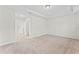 Bright bedroom features neutral walls, carpet, a ceiling fan, and attached walk-in closet at 13233 Canopy Creek Dr, Tampa, FL 33625
