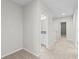 A hallway features a carpet flooring, neutral-colored walls, white trim and doors, and recessed lighting at 13233 Canopy Creek Dr, Tampa, FL 33625