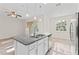 An eat-in kitchen shows an island with a granite countertop, stainless steel appliances, and light fixtures at 13233 Canopy Creek Dr, Tampa, FL 33625