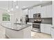 Modern kitchen with granite countertops, stainless steel appliances, and pendant lighting at 13233 Canopy Creek Dr, Tampa, FL 33625