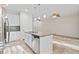 A modern kitchen features an island with a granite countertop, stainless steel appliances, and a dining area at 13233 Canopy Creek Dr, Tampa, FL 33625