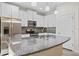 Modern kitchen with granite countertops, stainless steel appliances, and bright white cabinets at 13233 Canopy Creek Dr, Tampa, FL 33625
