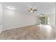 Spacious living room boasts tile floors and sliding glass doors for natural light and outdoor access at 13233 Canopy Creek Dr, Tampa, FL 33625