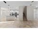 Inviting living area adjacent to the modern kitchen with white cabinets and stainless steel appliances at 13233 Canopy Creek Dr, Tampa, FL 33625