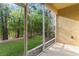 The screened-in patio provides a relaxing view of the backyard and greenery at 13233 Canopy Creek Dr, Tampa, FL 33625