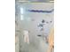 Shower with clear doors, built-in seating, and colorful fish decor at 135 143Rd E Ave, Madeira Beach, FL 33708