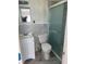 Bathroom featuring a glass-enclosed shower, new vanity, and marble-look tile walls at 14067 Marguerite Dr, Madeira Beach, FL 33708