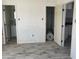 Bedroom with view of bathroom and storage room; shows paint in progress and new flooring at 14067 Marguerite Dr, Madeira Beach, FL 33708