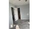 Bedroom showing updated gray flooring and fresh paint with doors to closet and bathroom at 14067 Marguerite Dr, Madeira Beach, FL 33708