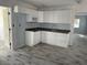 Updated kitchen featuring white cabinets, gray countertops, and new appliances at 14067 Marguerite Dr, Madeira Beach, FL 33708