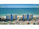 Aerial view of beachfront condo buildings with a pool, palm trees, and ocean view at 15000 Gulf Blvd # 602, Madeira Beach, FL 33708