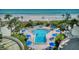 Aerial view of resort-style pool, surrounded by lush landscaping and steps away from sandy beach at 15000 Gulf Blvd # 602, Madeira Beach, FL 33708