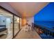 A cozy balcony featuring seating and serene ocean views at twilight at 15000 Gulf Blvd # 602, Madeira Beach, FL 33708