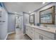 Large bathroom with double vanity and access to walk-in closet at 15000 Gulf Blvd # 602, Madeira Beach, FL 33708