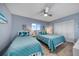 Comfortable guest bedroom with coastal accents and a ceiling fan at 15000 Gulf Blvd # 602, Madeira Beach, FL 33708