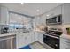 Bright kitchen with stainless steel appliances, white cabinets, and ocean view at 15000 Gulf Blvd # 602, Madeira Beach, FL 33708