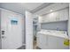 Bright laundry room featuring washer, dryer, storage cabinets, and closet space for convenience at 15000 Gulf Blvd # 602, Madeira Beach, FL 33708
