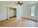 Bright bedroom with natural light, wood-look flooring, and closet, offering a cozy and functional space at 15307 Stonecreek Ln, Tampa, FL 33613