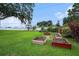 Green backyard with garden boxes and an established tree, perfect for gardening at 1744 Brookstone Way, Plant City, FL 33566