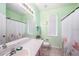 Well-lit bathroom featuring a shower with floral curtains, white counter, and tile flooring at 1744 Brookstone Way, Plant City, FL 33566