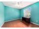 Bedroom featuring hardwood floors, light from a window and a built-in desk at 1744 Brookstone Way, Plant City, FL 33566