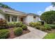 Inviting front entrance with manicured shrubs and mulch, leading to a warm-toned front door at 1744 Brookstone Way, Plant City, FL 33566