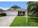 Charming single-story home with a well-manicured lawn and a two-car garage at 1744 Brookstone Way, Plant City, FL 33566