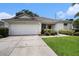 Single-story home featuring an attached two-car garage and meticulously kept lawn at 1744 Brookstone Way, Plant City, FL 33566
