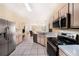 Well-equipped kitchen featuring stainless steel appliances, tile floors and light wood cabinets at 1744 Brookstone Way, Plant City, FL 33566