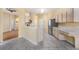 Open kitchen featuring tile floors, light wood cabinets and stainless steel refrigerator at 1744 Brookstone Way, Plant City, FL 33566