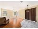 Living room with wood flooring, ceiling fan, windows, and access to the kitchen at 1744 Brookstone Way, Plant City, FL 33566