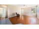 Open living room with tile-to-wood floor transition, ceiling fan and natural light at 1744 Brookstone Way, Plant City, FL 33566
