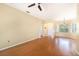 Open living space with wood floors, ceiling fan, and versatile layout at 1744 Brookstone Way, Plant City, FL 33566