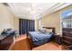 Primary bedroom with wood flooring, ceiling fan and a sunny window at 1744 Brookstone Way, Plant City, FL 33566