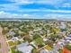 Lovely aerial shot of a vibrant residential community with lush trees, paved streets, and waterfront properties under a blue sky at 1810 Maryland Ne Ave, St Petersburg, FL 33703
