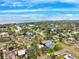 Scenic aerial view of neighborhood homes with pond, ocean and cloudy sky at 1810 Maryland Ne Ave, St Petersburg, FL 33703
