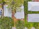 Aerial view of homes with light gray rooftops surrounded by mature trees at 1810 Maryland Ne Ave, St Petersburg, FL 33703
