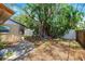 Backyard with mature trees and partial fencing, providing a natural and private setting at 1810 Maryland Ne Ave, St Petersburg, FL 33703