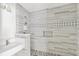 Modern tiled bathroom featuring a stylish shower with a decorative inlay and a sleek vanity at 1810 Maryland Ne Ave, St Petersburg, FL 33703
