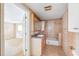 Bathroom with peach tile, vanity, and bathtub shower, connected to another room at 1810 Maryland Ne Ave, St Petersburg, FL 33703