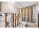 Bathroom that requires repairs showing exposed framing, a toilet, and a shower with a plaid curtain at 1810 Maryland Ne Ave, St Petersburg, FL 33703