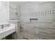 Modern bathroom features gray tile walls with decorative trim and a stylish vanity at 1810 Maryland Ne Ave, St Petersburg, FL 33703