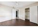 Bedroom with wood floors, closet, and an open door, showing signs of water damage at 1810 Maryland Ne Ave, St Petersburg, FL 33703