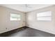Bedroom with wood floors, two windows, and a ceiling fan, in need of repair at 1810 Maryland Ne Ave, St Petersburg, FL 33703