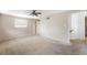 Empty bedroom with ceiling fan and doorway. Needs painting, carpet cleaning, and restoration at 1810 Maryland Ne Ave, St Petersburg, FL 33703