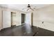Spacious bedroom features dark wood floors, a ceiling fan, closet, and an attached bathroom at 1810 Maryland Ne Ave, St Petersburg, FL 33703